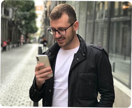Person using smartphone on street
